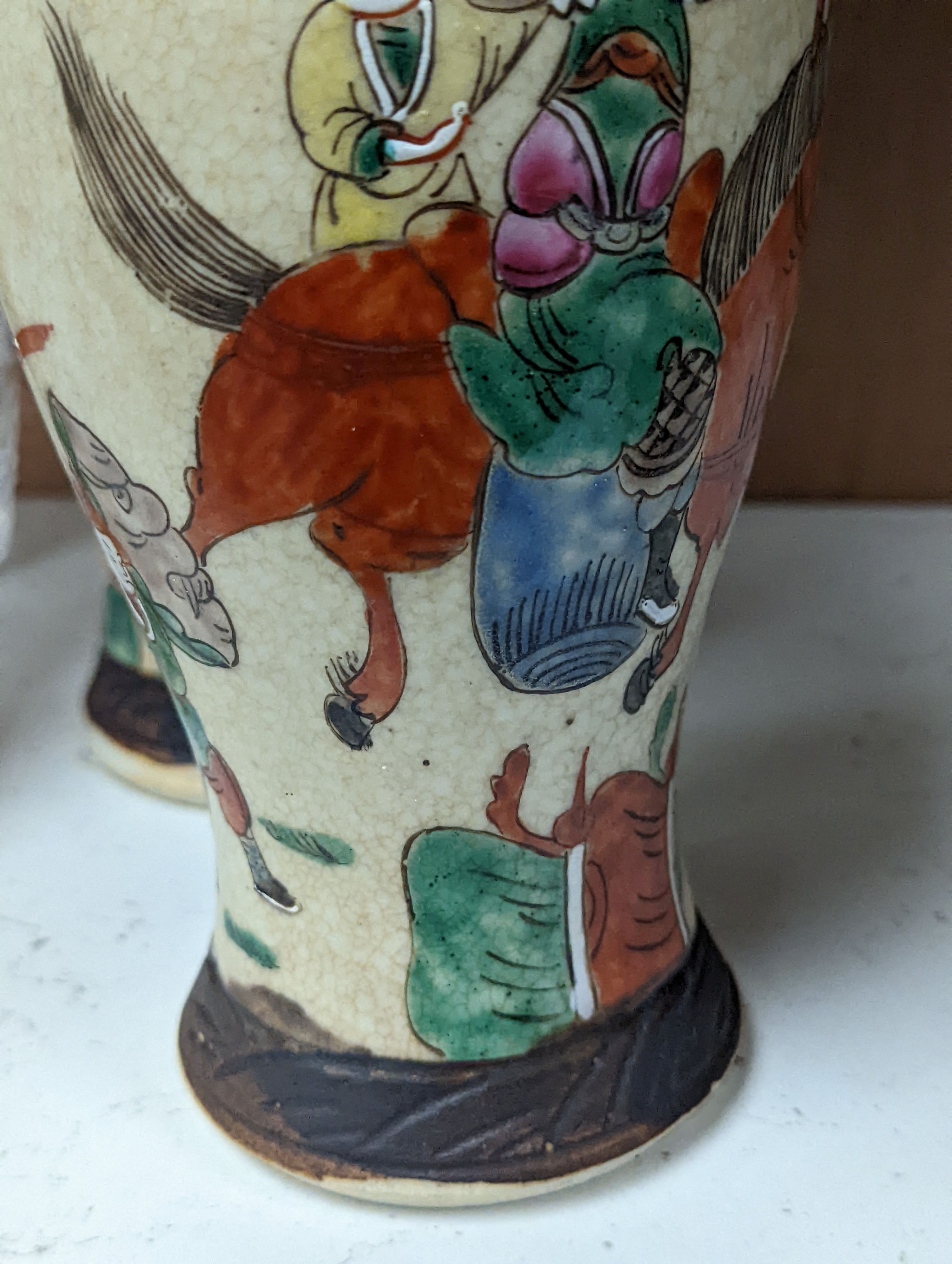 A pair of Chinese famille rose crackle glaze baluster jars and covers, 27cm.
